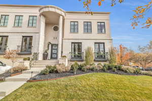 View of front of home featuring a front yard and french doors