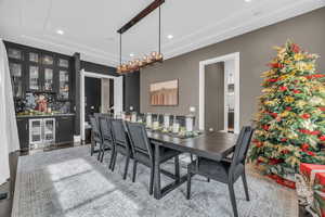 Dining area with indoor bar, light hardwood / wood-style flooring, and wine cooler