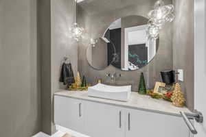 Bathroom with decorative backsplash and vanity