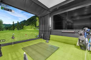 Game room with carpet floors and golf simulator