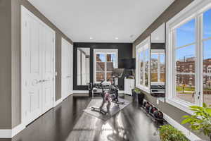 Workout room with french doors and dark hardwood / wood-style floors