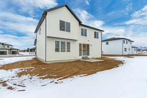 View of snow covered rear of property