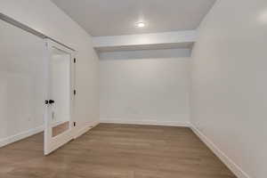 Empty room with hardwood / wood-style floors