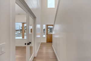 Corridor with light hardwood / wood-style floors and a wealth of natural light