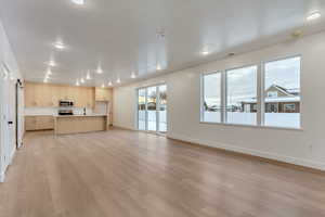 Unfurnished living room with light wood-type flooring