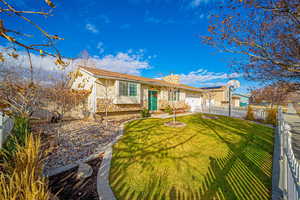 Ranch-style house featuring a front yard and a garage