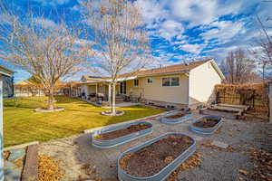 Back of house featuring a lawn and a patio area