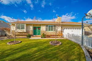 Ranch-style house with a garage and a front yard