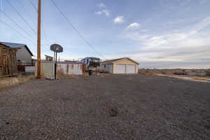 View of front of property featuring a garage and an outdoor structure