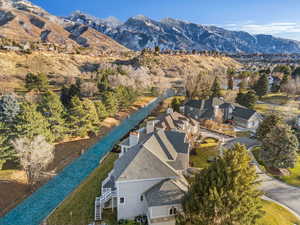 Drone / aerial view with a mountain view and Little Cottonwood Creek in the back yard