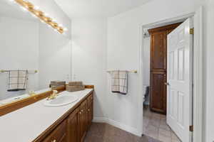 Full Bathroom with tile patterned floors, vanity, and toilet