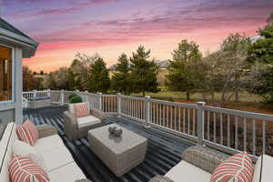 Deck at dusk with an outdoor hangout area