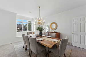 Freshly carpeted and painted formal dining area with large picture window and seat facing west