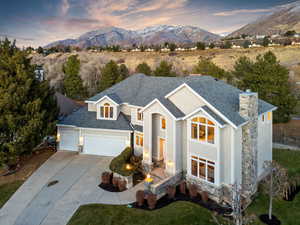 View of front of property with a mountain view and a garage