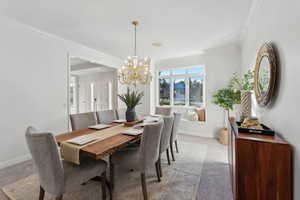 Freshly carpeted and painted formal dining area with large picture window and seat facing west