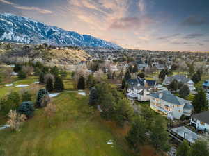 Aerial view at dusk with a mountain view and Willow Creek Golf Course