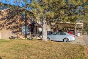 Exterior space featuring a lawn and a carport