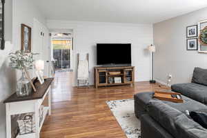 Living room with hardwood / wood-style flooring and ceiling fan