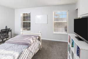 Bedroom featuring dark carpet