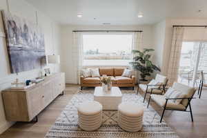 Picture is of model home. Living room featuring light wood-type flooring