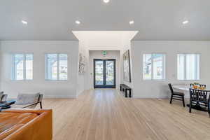 Entryway with plenty of natural light and light wood-type flooring