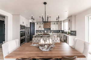 Dining area with light hardwood / wood-style floors and sink