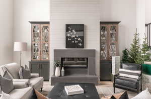 Living room featuring a large fireplace and light hardwood / wood-style floors