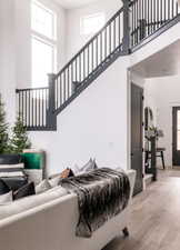 Living room featuring a high ceiling and light hardwood / wood-style flooring