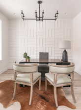 Living area featuring light wood-type flooring and a chandelier