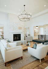 Living room with hardwood / wood-style floors and a large fireplace