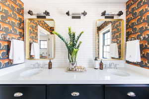 Bathroom featuring vanity and backsplash