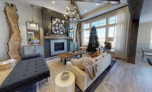 Living room with an inviting chandelier and light hardwood / wood-style flooring