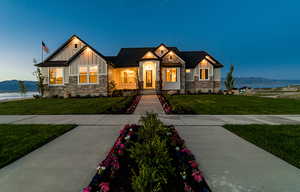 Craftsman-style house with a lawn and a water and mountain view