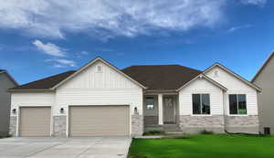 View of front of home featuring a garage and a front lawn