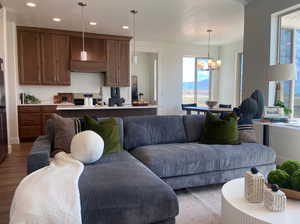 Living room featuring hardwood / wood-style flooring and a chandelier