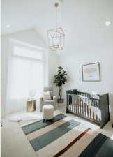 Bedroom featuring carpet flooring, a nursery area, a chandelier, high vaulted ceiling, and recessed lighting