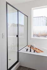 Bathroom with tile patterned floors and independent shower and bath
