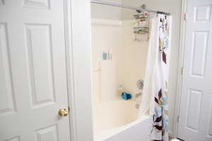 Bathroom with shower / tub combo with curtain