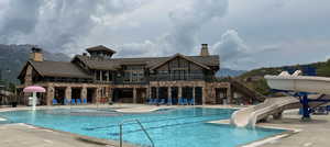 View of pool with a mountain view and a water slide