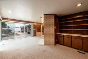 Light, open family room off kitchen with extra cooktop, fireplace, closet space and walkout slider to backyard patio