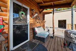 Wooden terrace featuring grilling area