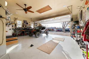 Garage with a workshop area and ceiling fan