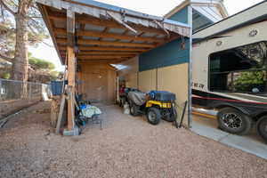 View of vehicle parking featuring a carport