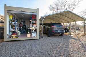 View of parking / parking lot with a carport