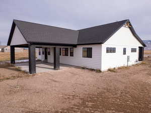 Rear view of house featuring a patio