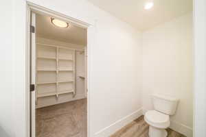 Bathroom featuring wood-type flooring and toilet