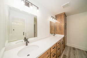 Bathroom featuring vanity and wood-type flooring