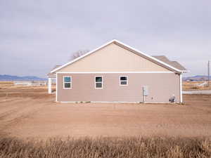 View of side of home featuring a mountain view