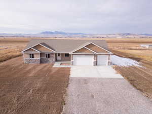 View of front facade with a mountain view, a porch, and a garage