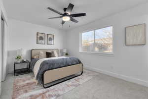 Carpeted bedroom featuring ceiling fan